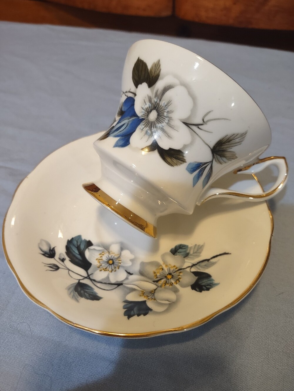White Floral Bone China Teacup & Saucer with Blue Accents and Gold Trim